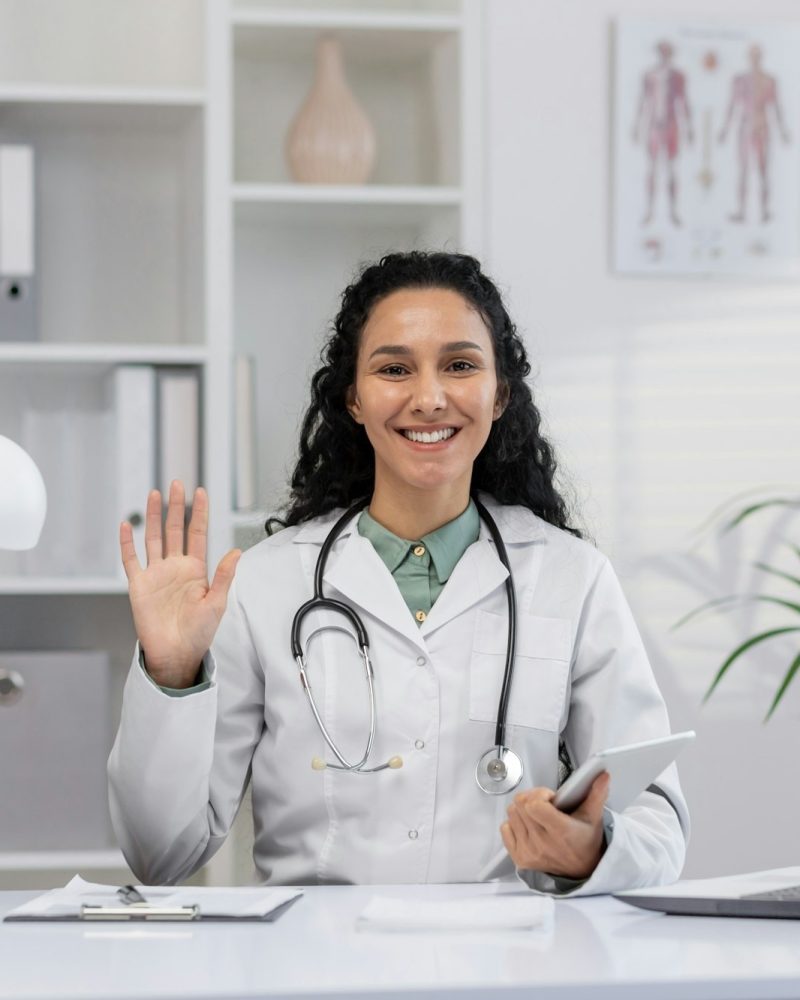 friendly-female-doctor-greeting-with-a-smile-in-clinic